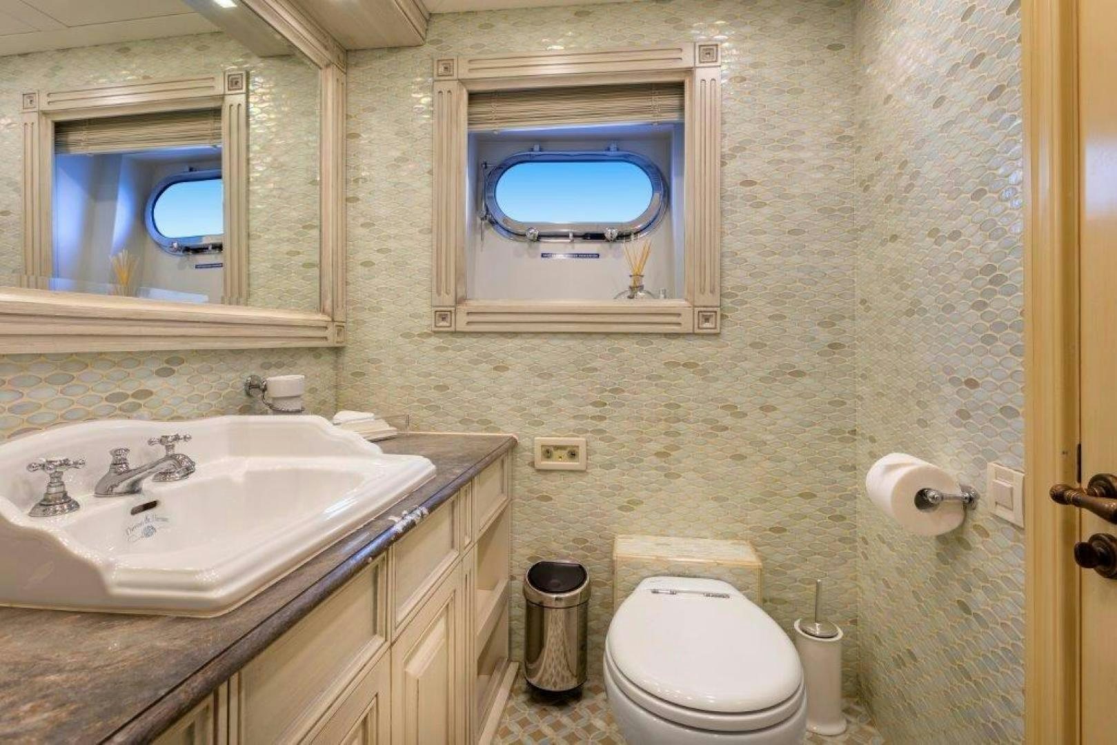 a bathroom with a sink toilet and a mirror aboard M&M Yacht for Sale