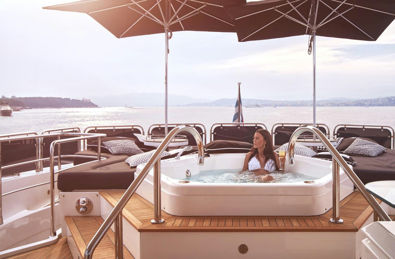 a person sitting on a boat aboard BLACK AND WHITE Yacht for Sale