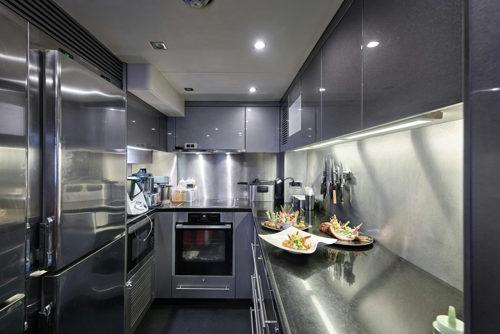 a kitchen with stainless steel appliances aboard BLACK AND WHITE Yacht for Sale