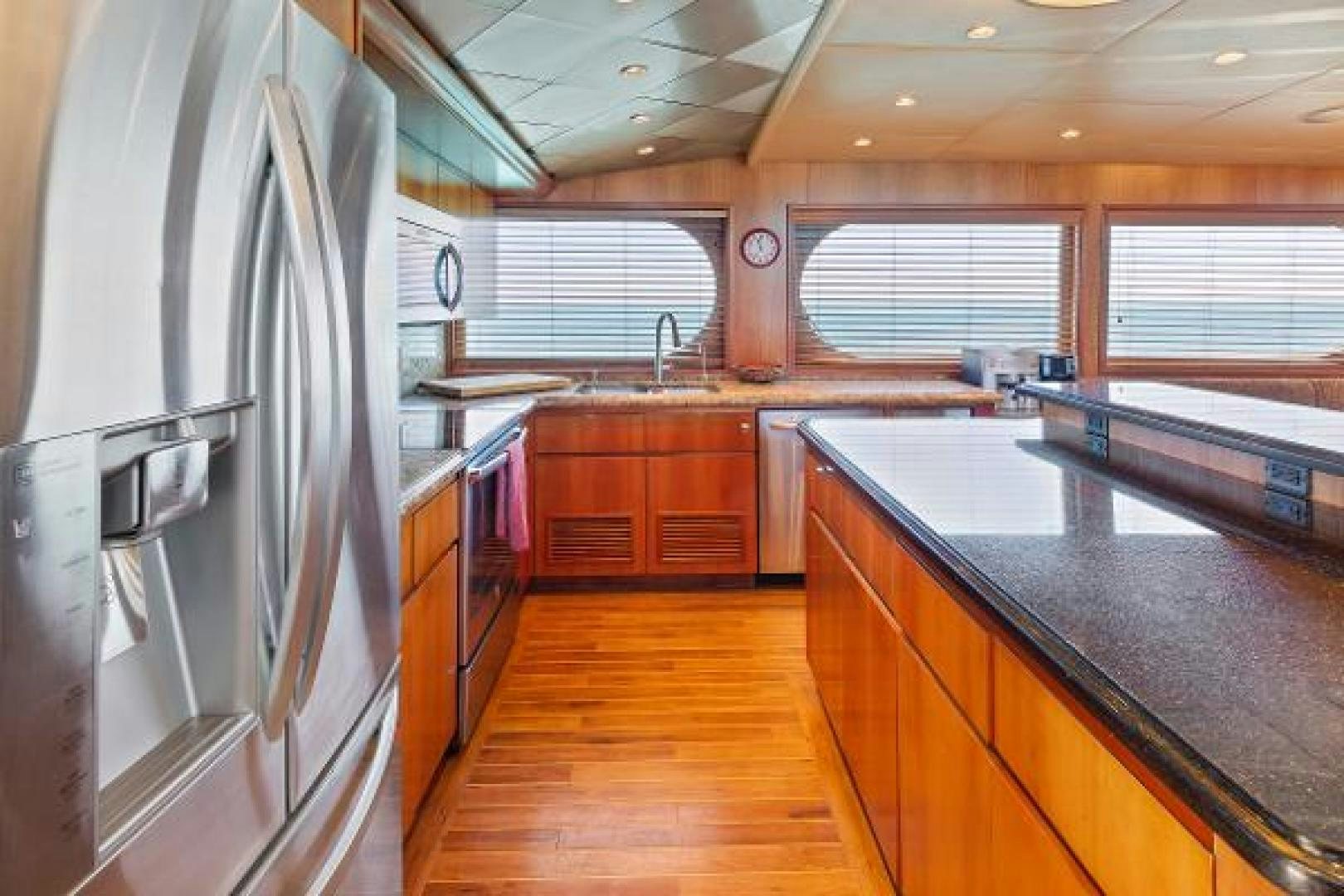 a kitchen with a large island aboard IL CAPO Yacht for Sale