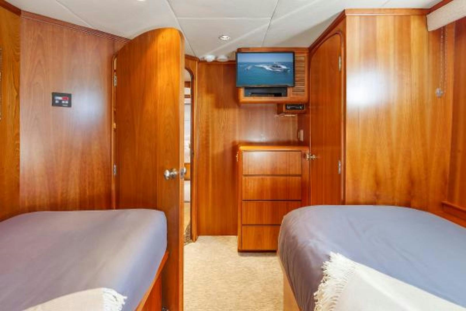 a room with a bed and a television aboard IL CAPO Yacht for Sale