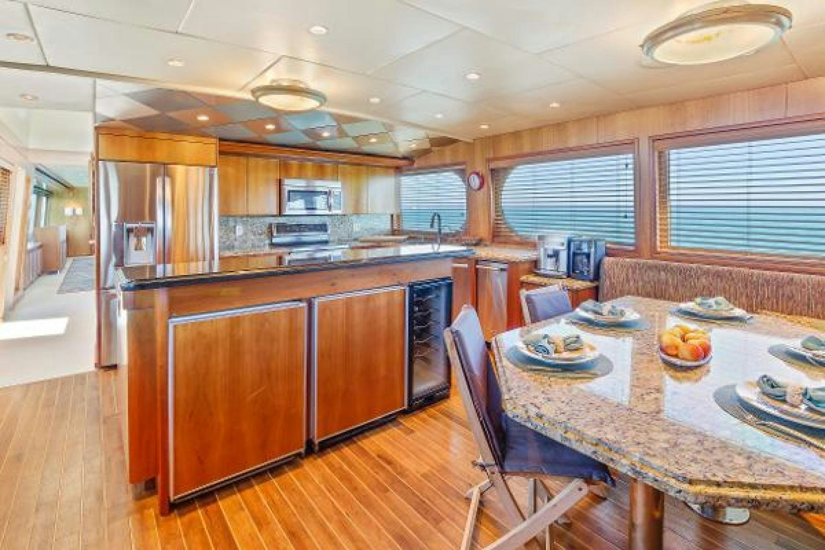 a kitchen with a table and chairs aboard IL CAPO Yacht for Sale