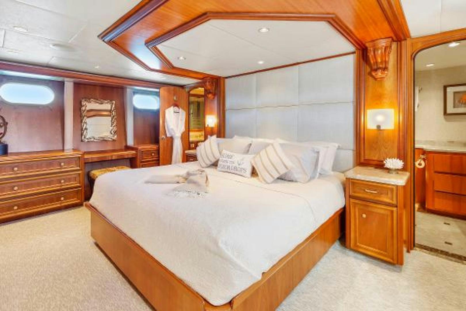 a bedroom with a bed and a mirror aboard IL CAPO Yacht for Sale
