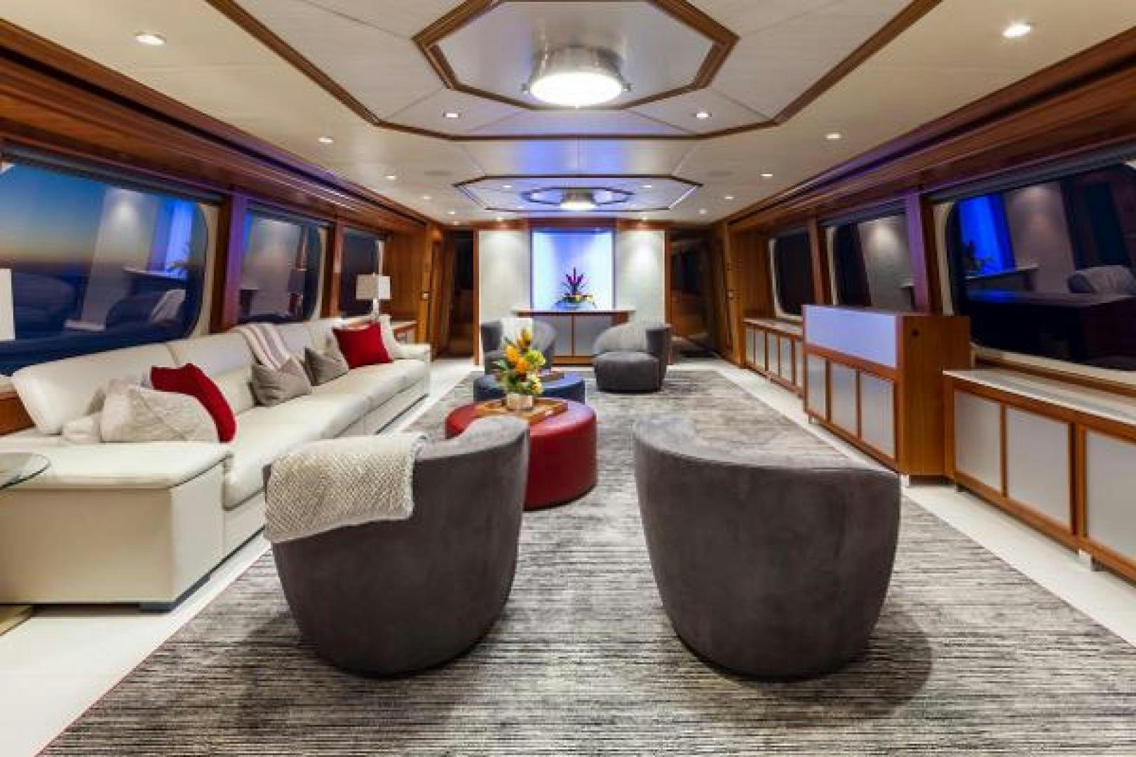 a living room with a large sofa and a large television aboard IL CAPO Yacht for Sale