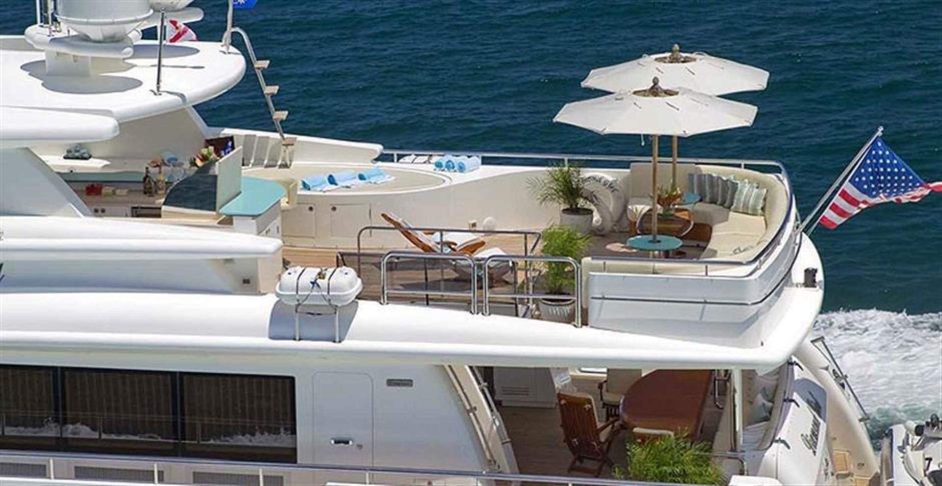 a boat with chairs and umbrellas aboard JOHNSON 110 FLYBRIDGE Yacht for Sale