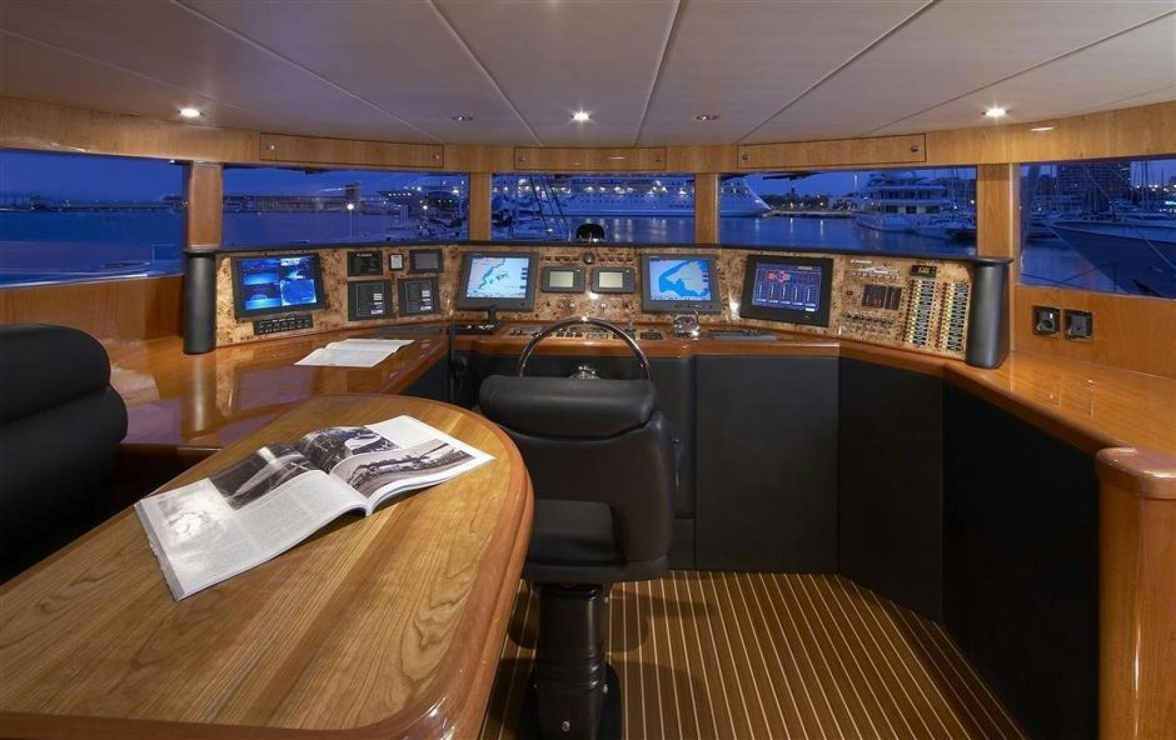 a room with a desk and chairs aboard JOHNSON 110 FLYBRIDGE Yacht for Sale