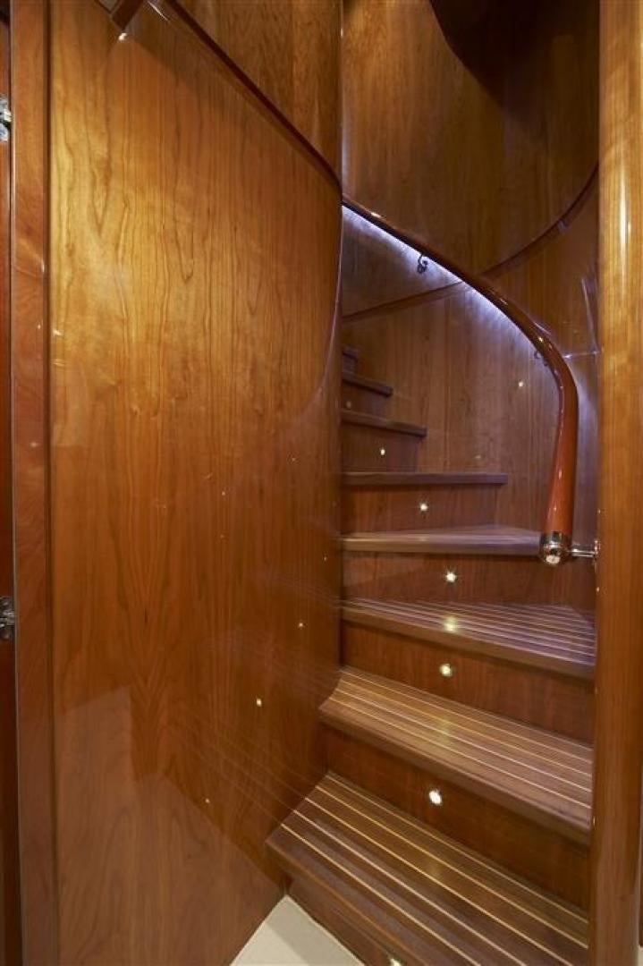 a wooden door with a metal handle aboard JOHNSON 110 FLYBRIDGE Yacht for Sale