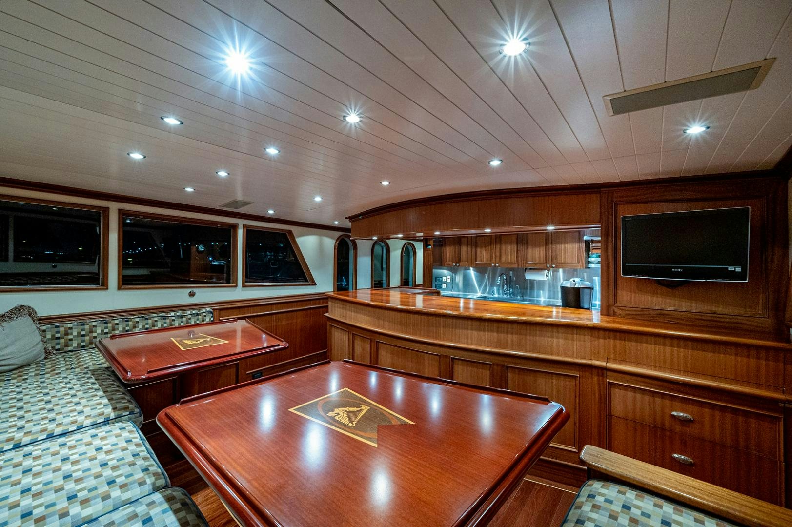 a kitchen with a table and tv aboard CHANTICLEER Yacht for Sale