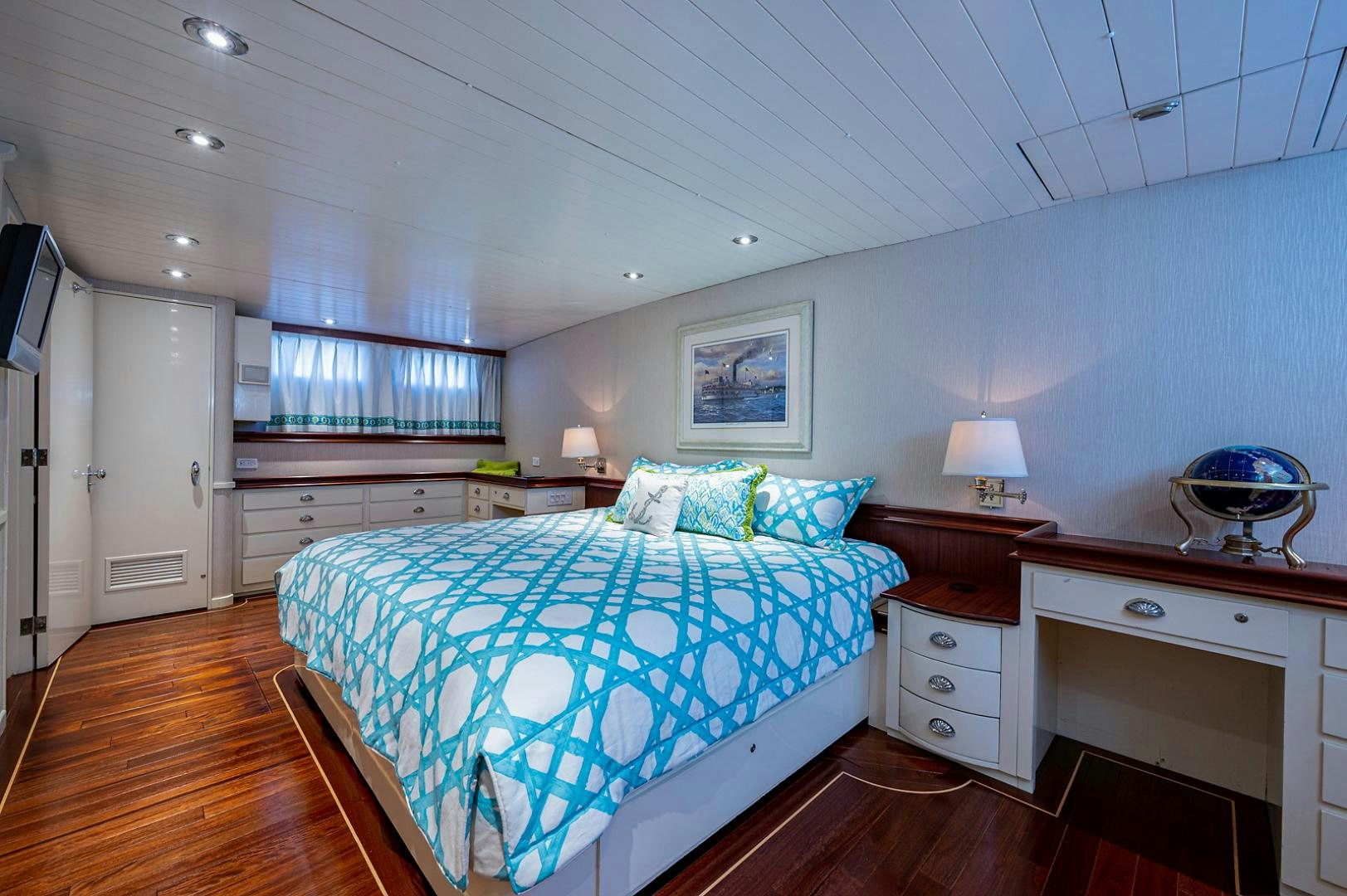 a bedroom with a bed and a desk aboard CHANTICLEER Yacht for Sale