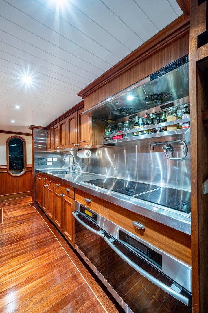 a kitchen with a large glass wall aboard CHANTICLEER Yacht for Sale