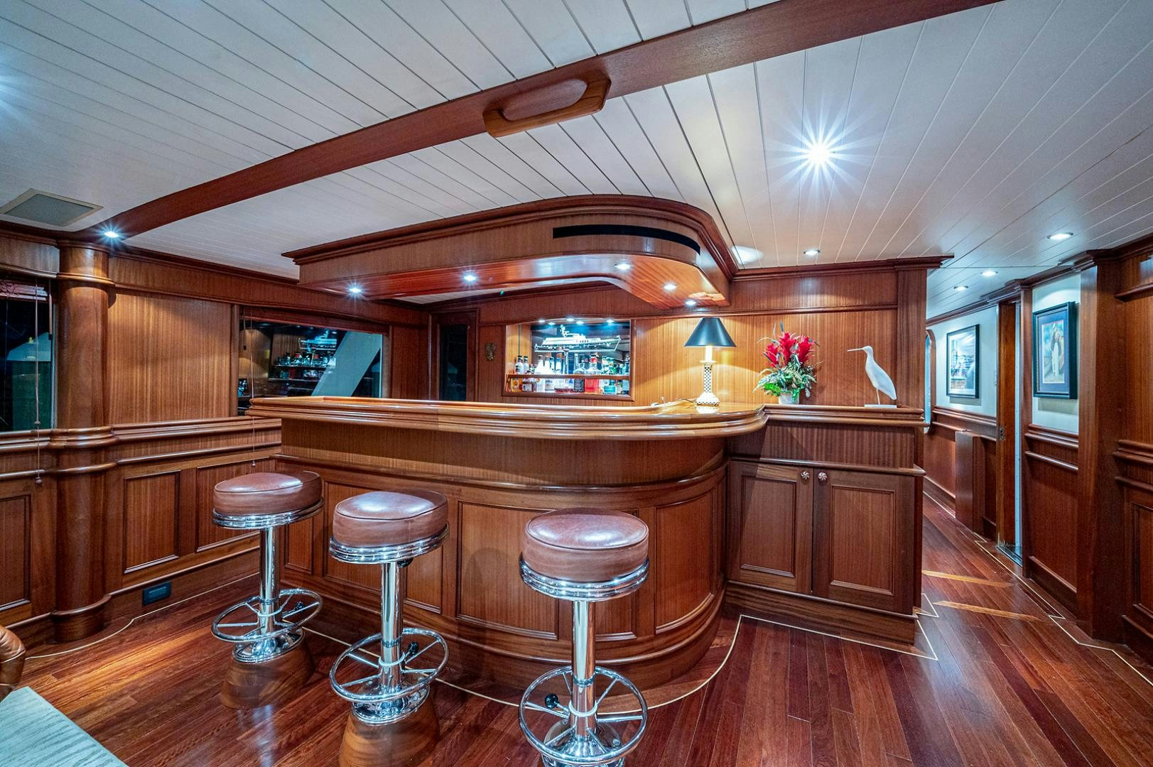 a kitchen with a bar and stools aboard CHANTICLEER Yacht for Sale