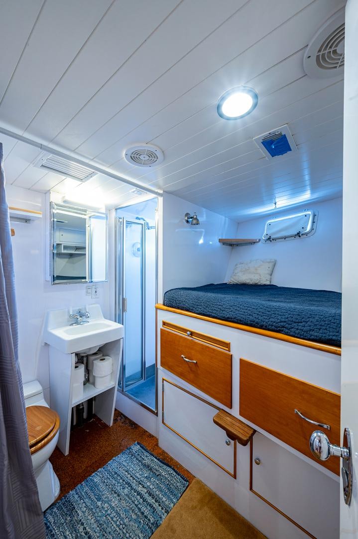a small bathroom with a blue bed aboard CHANTICLEER Yacht for Sale