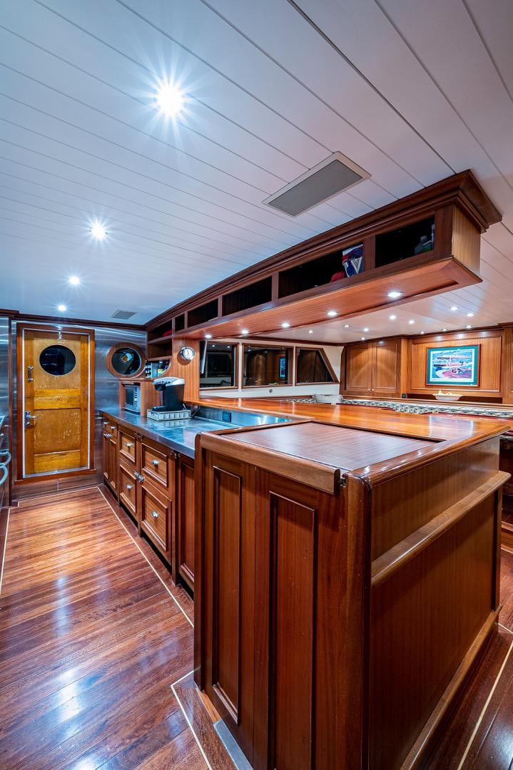 a kitchen with a large island aboard CHANTICLEER Yacht for Sale