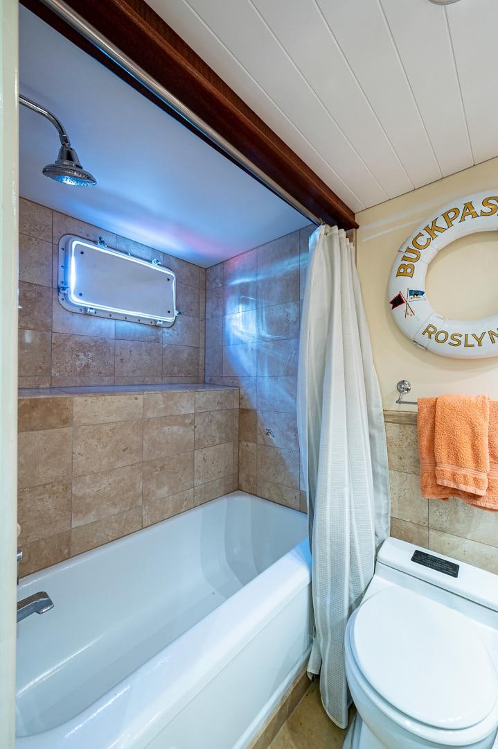 a bathroom with a tub toilet and sink aboard CHANTICLEER Yacht for Sale