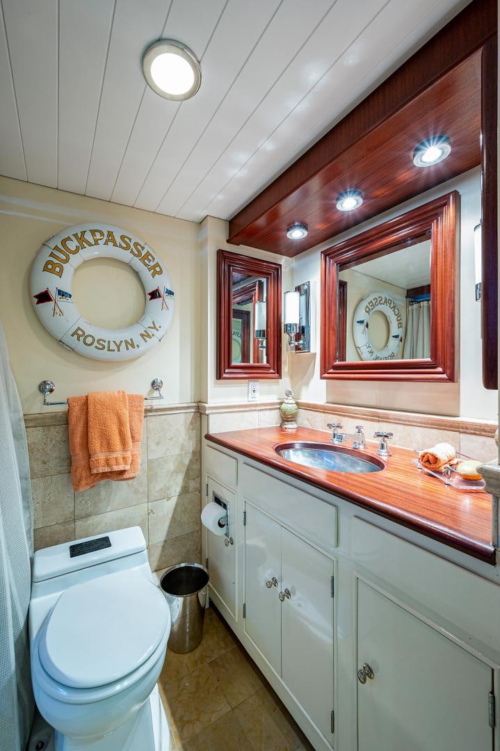 a bathroom with a sink toilet and a mirror aboard CHANTICLEER Yacht for Sale