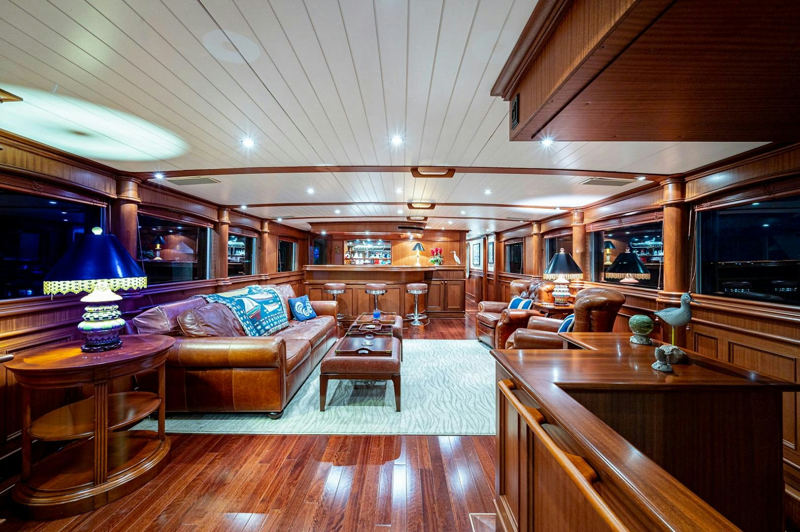 a living room with a wood floor aboard CHANTICLEER Yacht for Sale