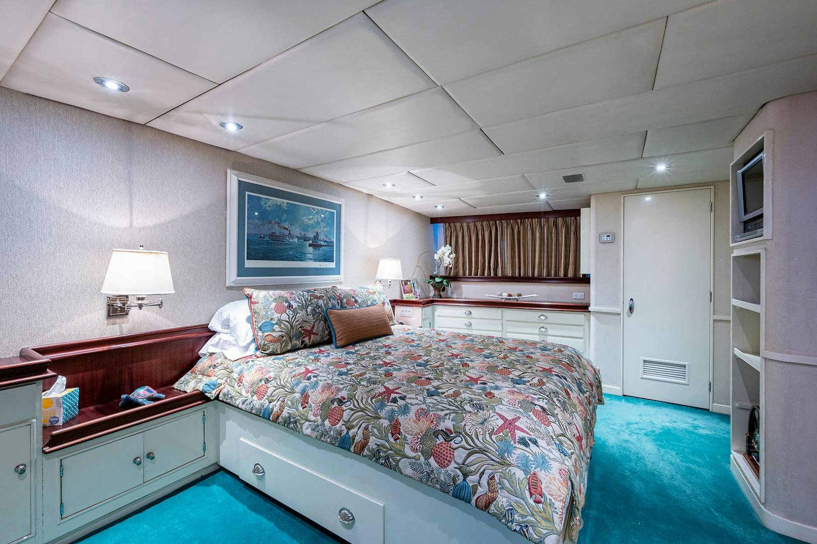a bedroom with a bed and a desk aboard CHANTICLEER Yacht for Sale
