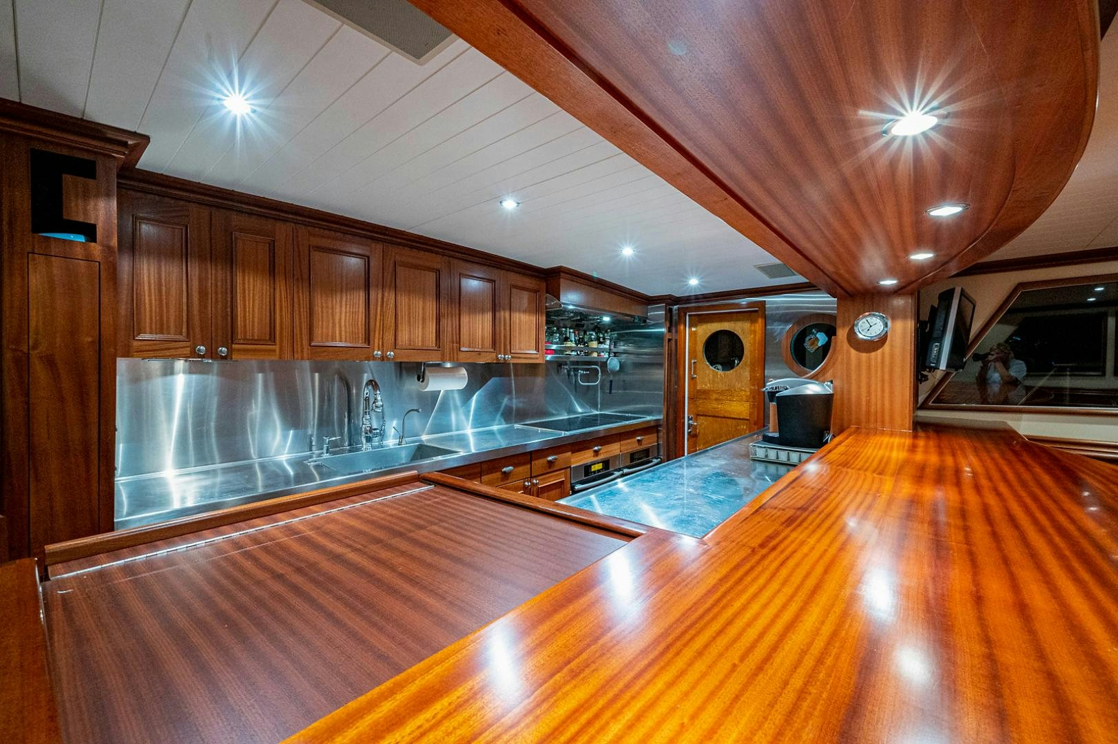 a large kitchen with wooden cabinets aboard CHANTICLEER Yacht for Sale