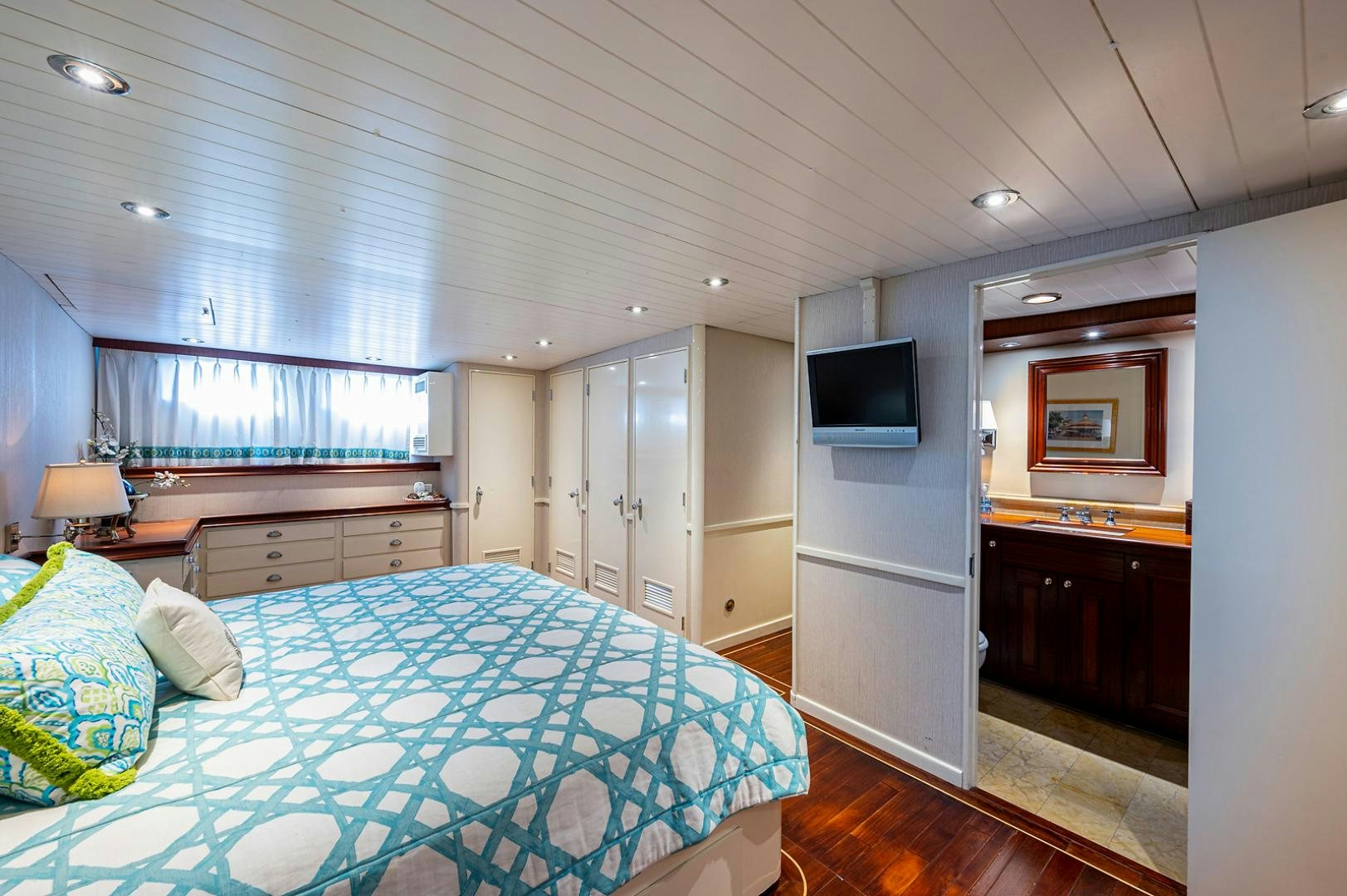 a bedroom with a bed and a tv aboard CHANTICLEER Yacht for Sale