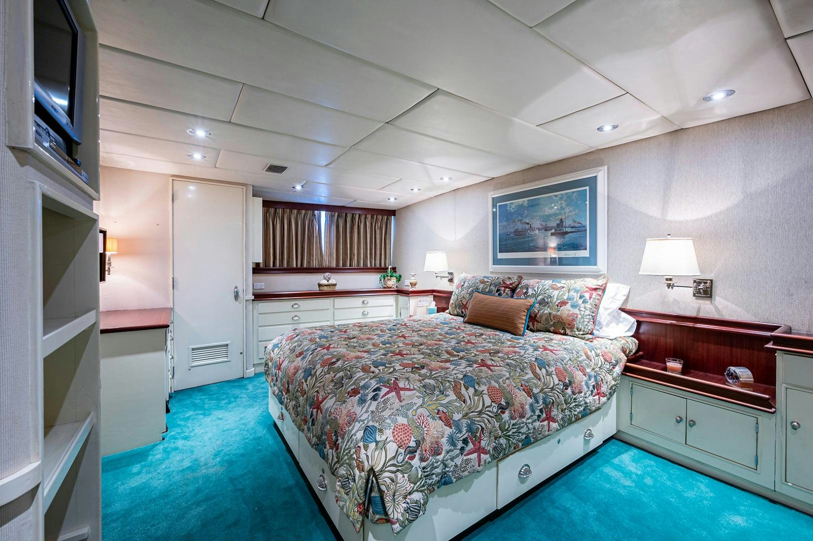 a bedroom with a bed and a desk aboard CHANTICLEER Yacht for Sale