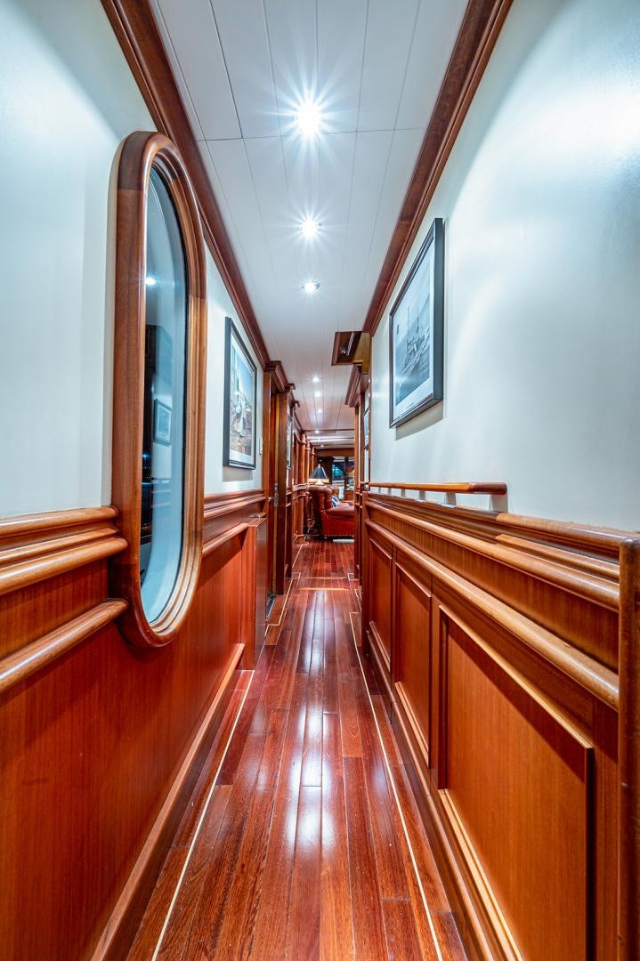 a long hallway with wooden benches aboard CHANTICLEER Yacht for Sale