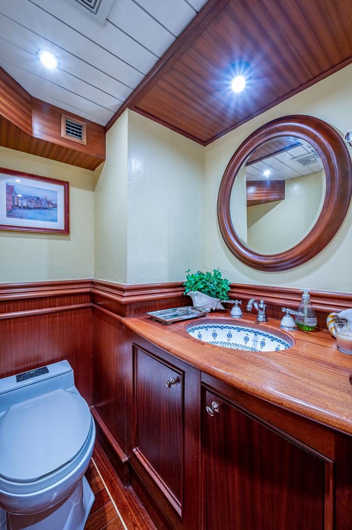 a bathroom with a sink and a mirror aboard CHANTICLEER Yacht for Sale