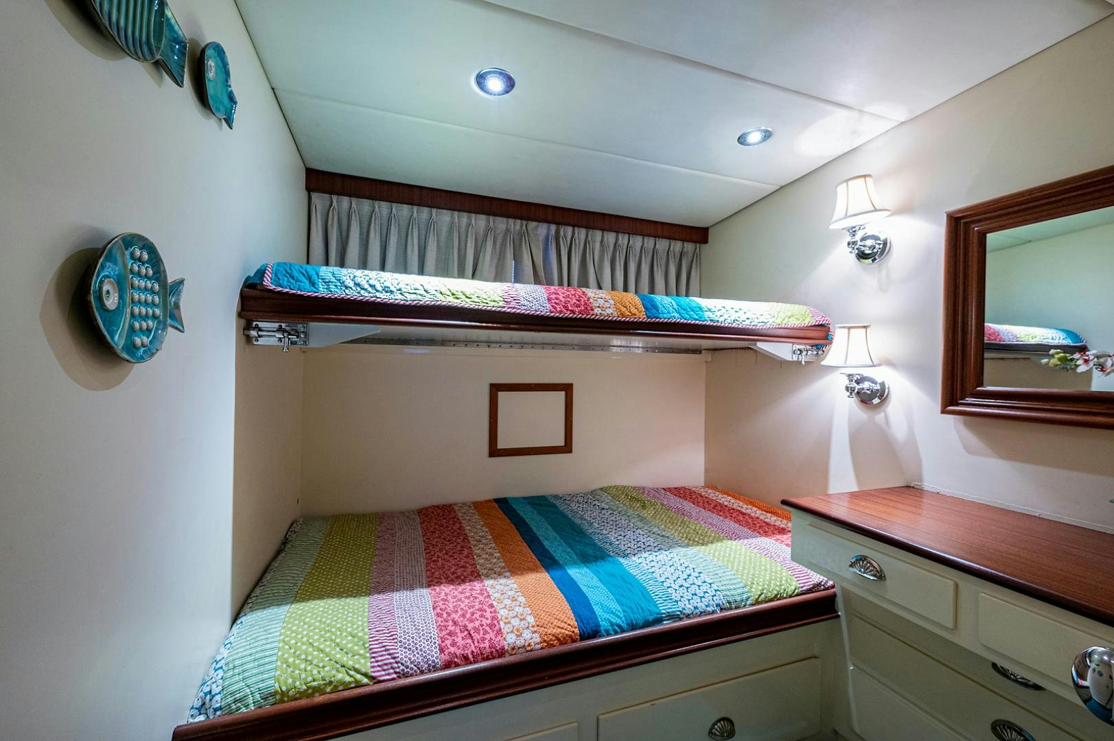 a bedroom with a bed and a mirror aboard CHANTICLEER Yacht for Sale