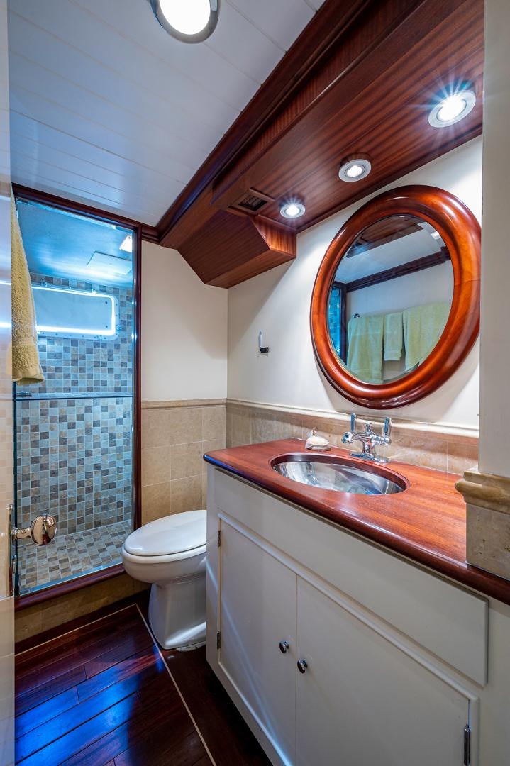 a bathroom with a sink and a mirror aboard CHANTICLEER Yacht for Sale