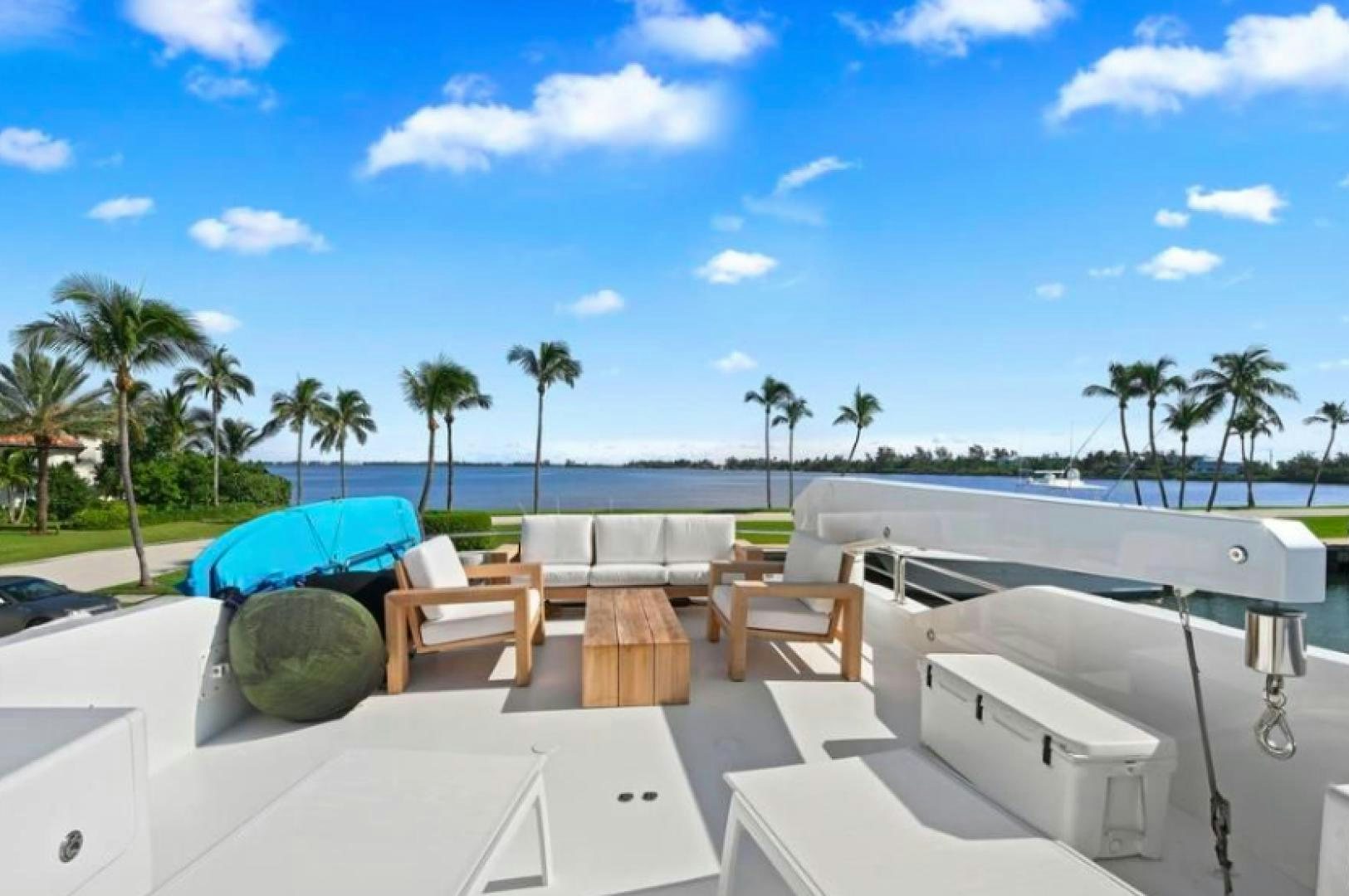 a lounge area with chairs and umbrellas on it aboard RAISING DOUGH Yacht for Sale