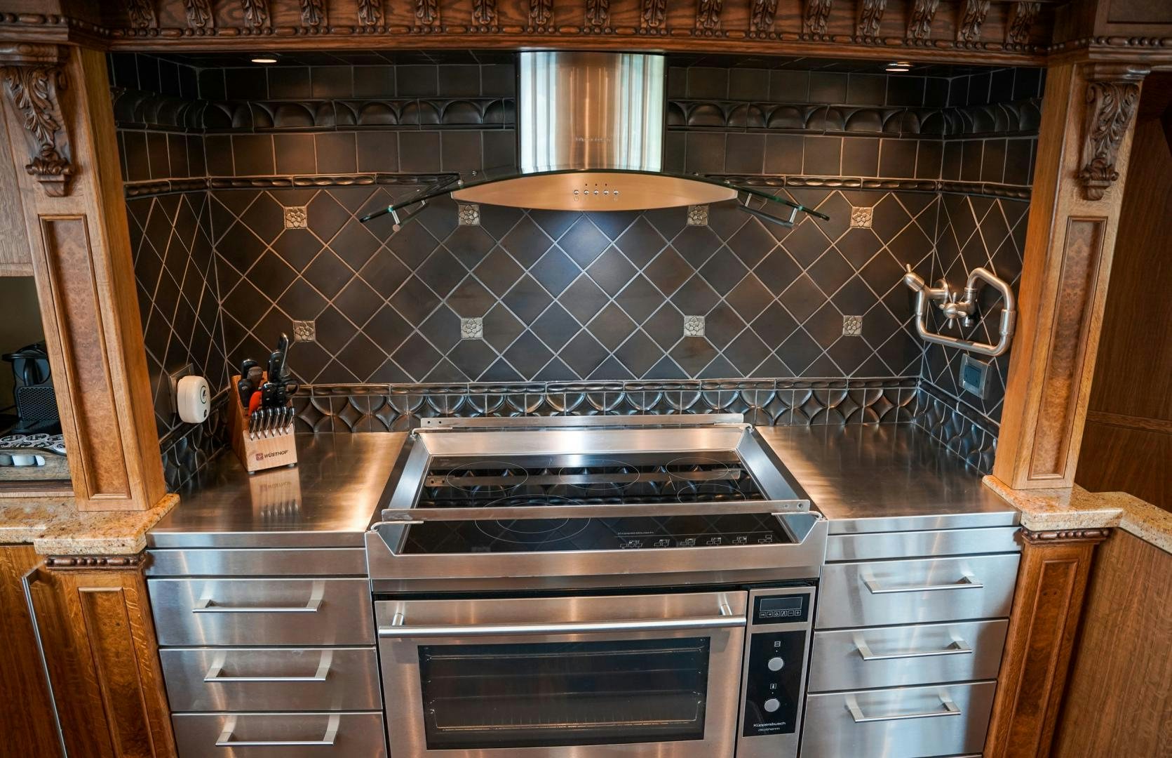 a kitchen with a stove and a chimney aboard RAISING DOUGH Yacht for Sale