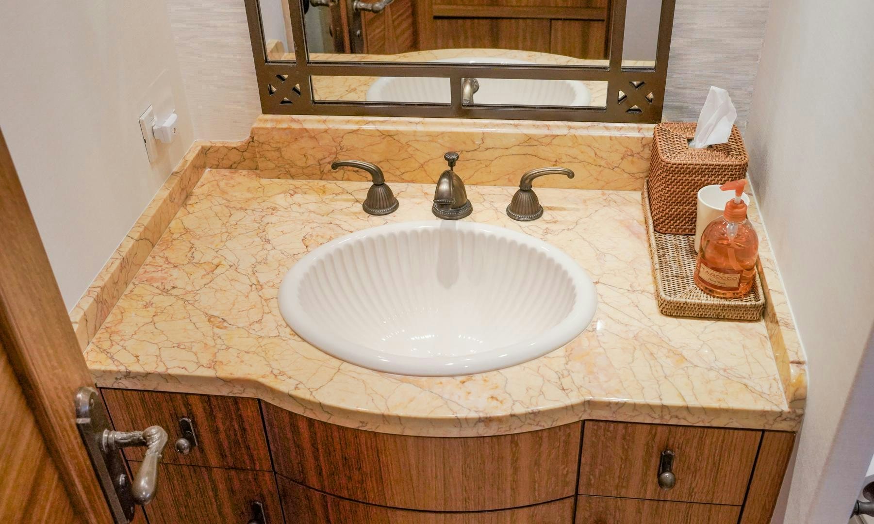 a bathroom sink with a mirror above it aboard RAISING DOUGH Yacht for Sale