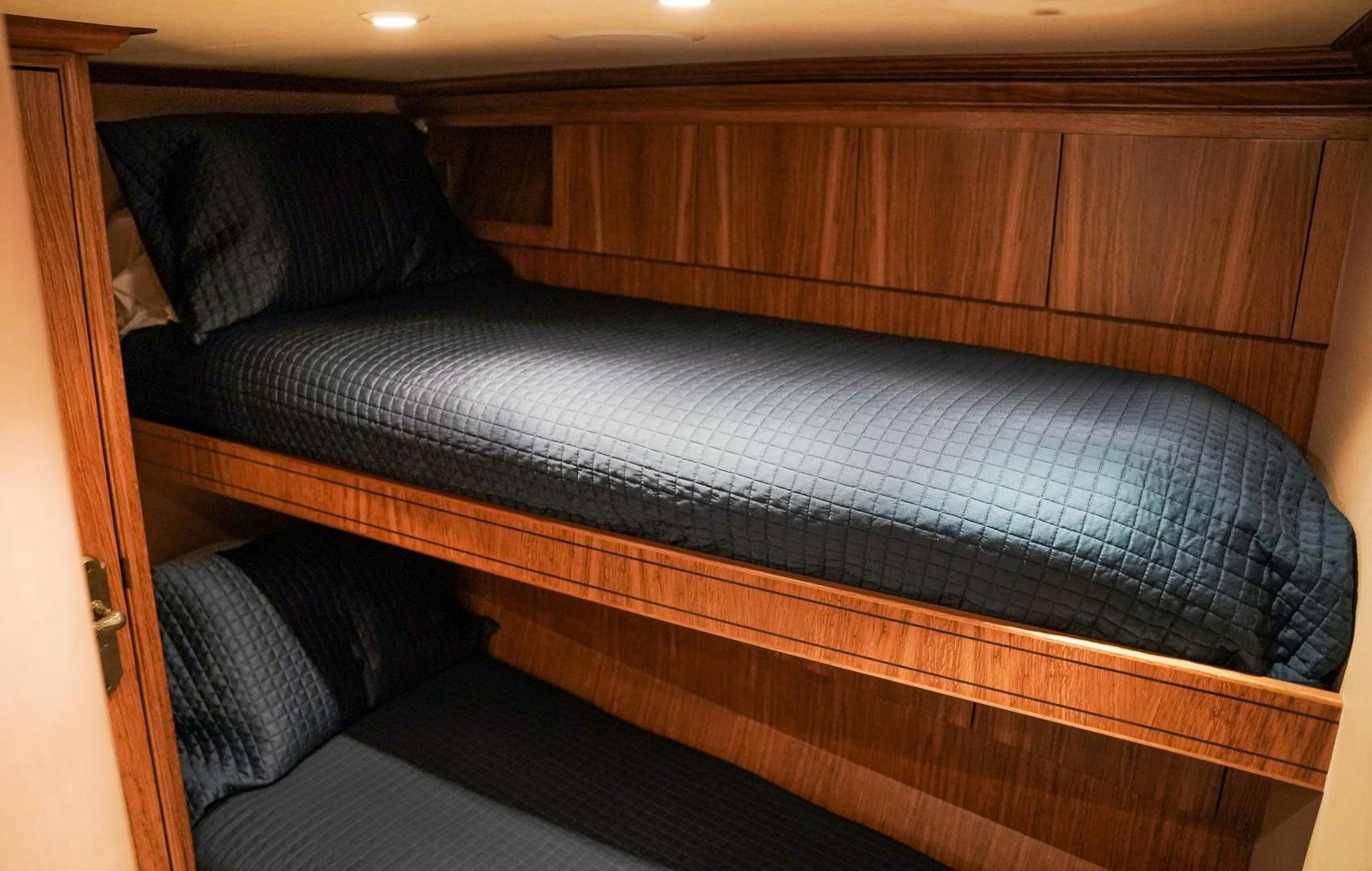 a bed with a blue comforter aboard RAISING DOUGH Yacht for Sale