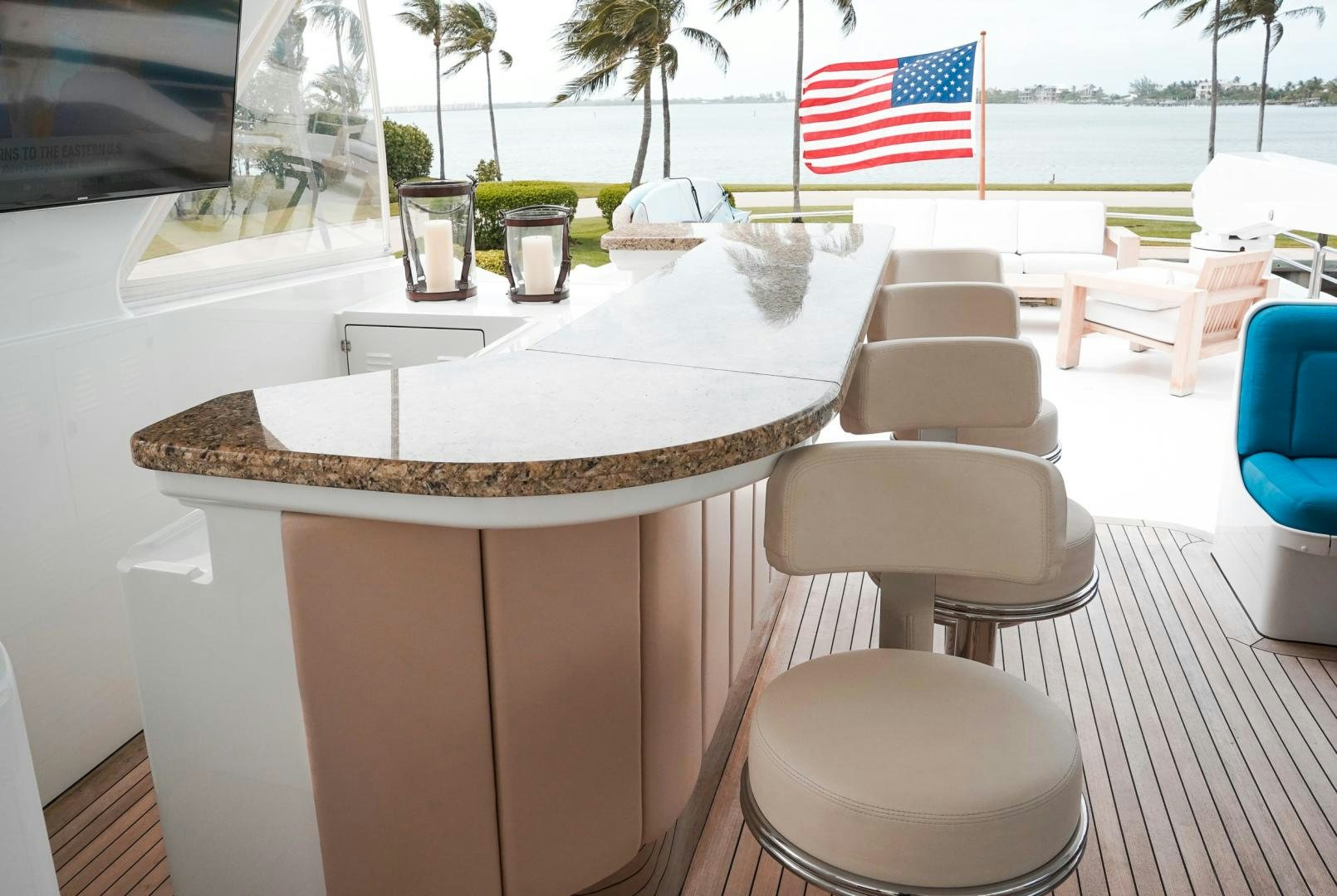 a table with chairs and a flag on it aboard RAISING DOUGH Yacht for Sale