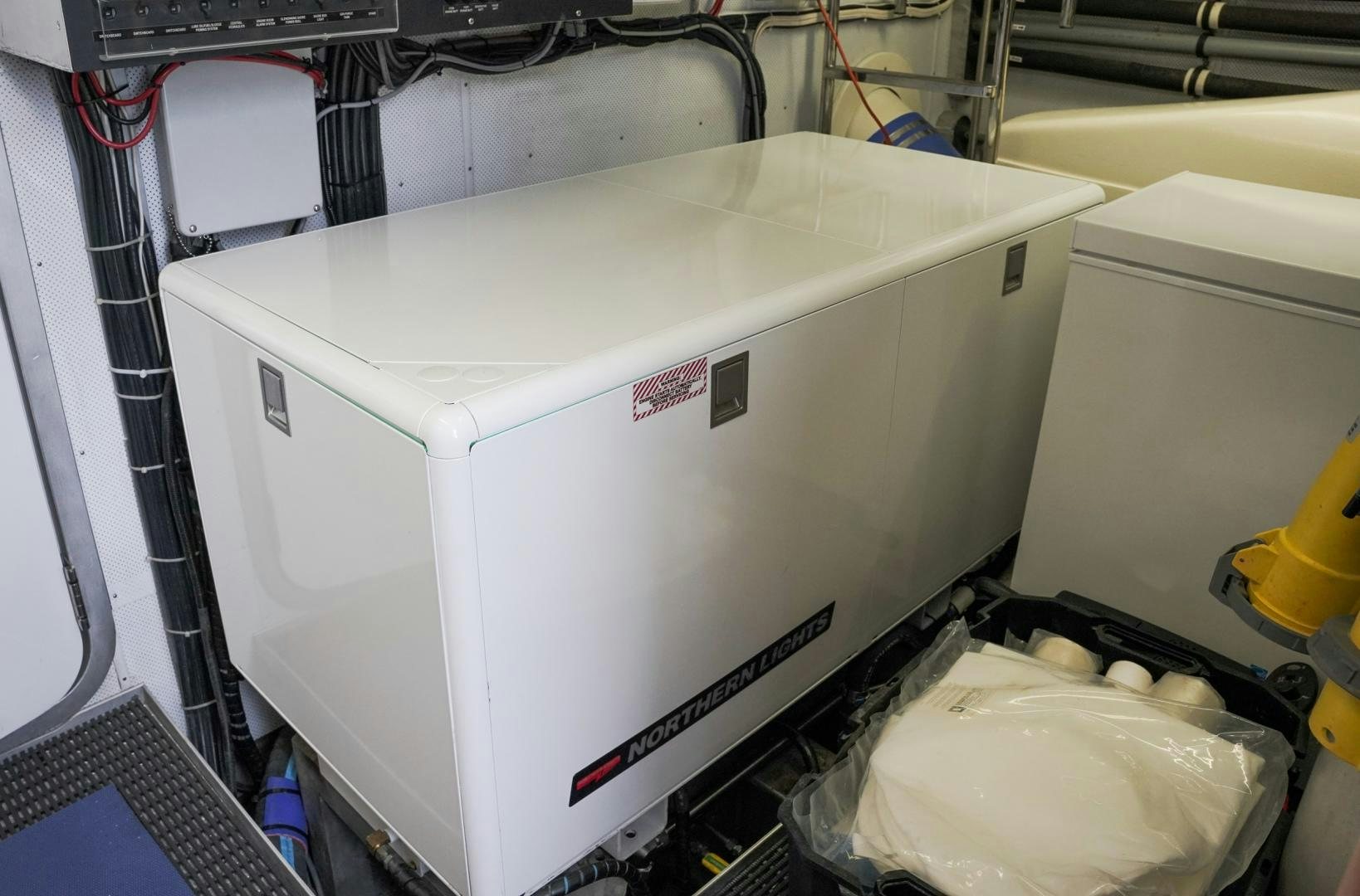 a white box with a red and black label on it aboard RAISING DOUGH Yacht for Sale