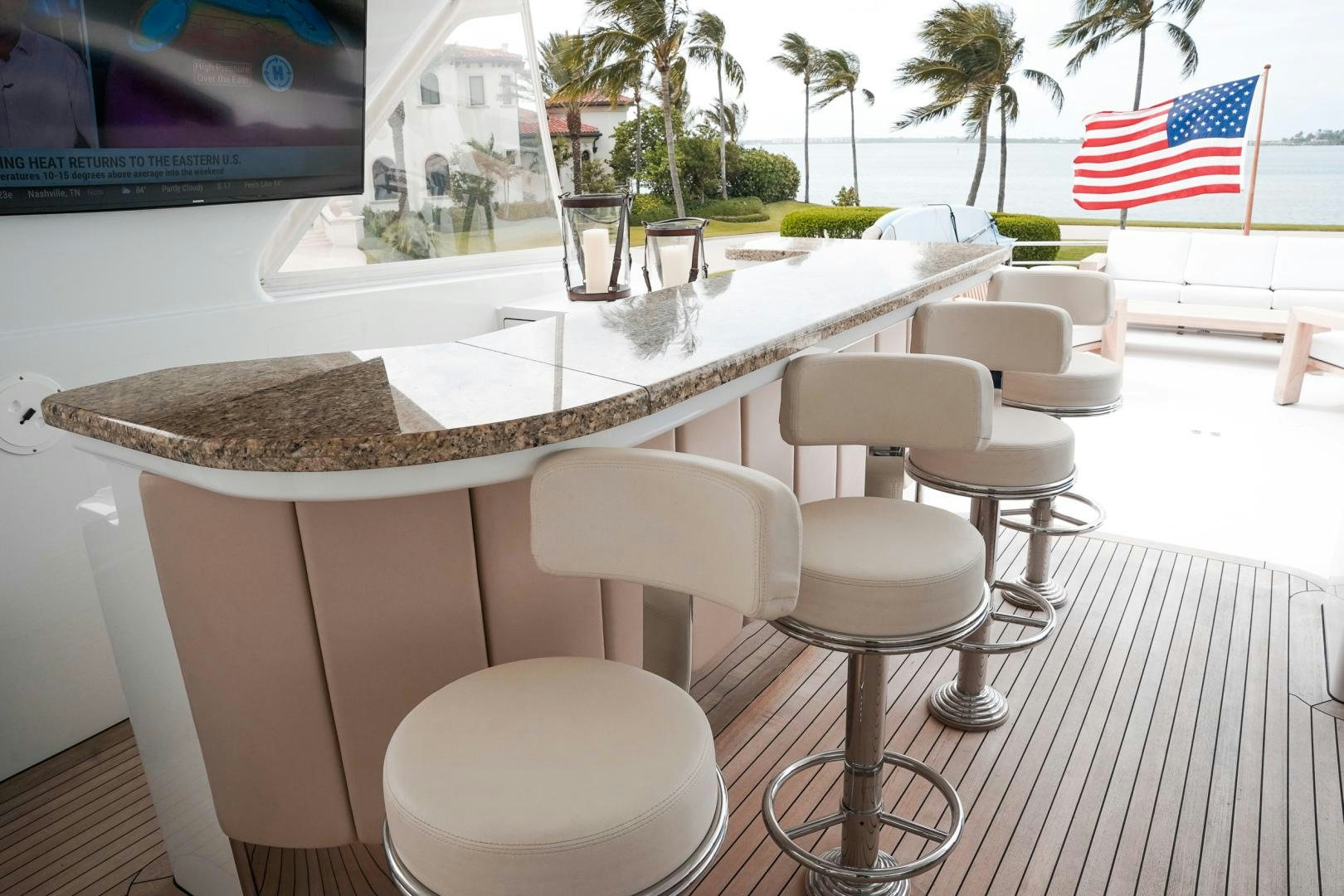 a table with chairs and a flag aboard RAISING DOUGH Yacht for Sale
