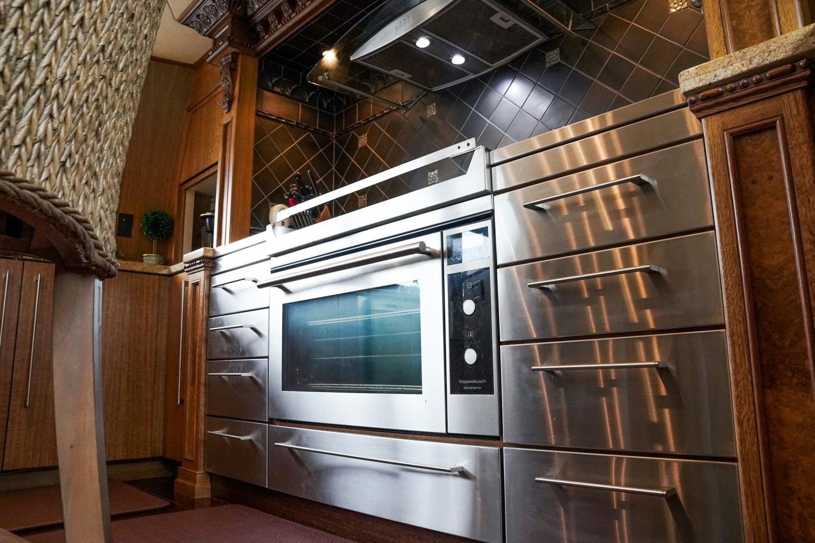 a kitchen with wooden cabinets aboard RAISING DOUGH Yacht for Sale