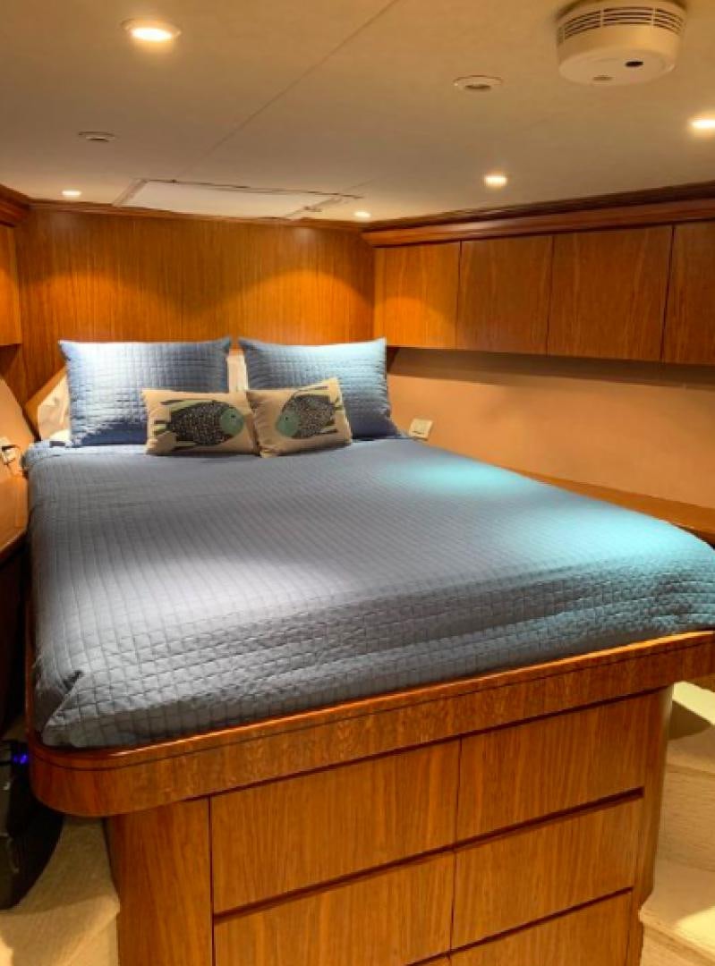 a bed with a blue comforter aboard RAISING DOUGH Yacht for Sale