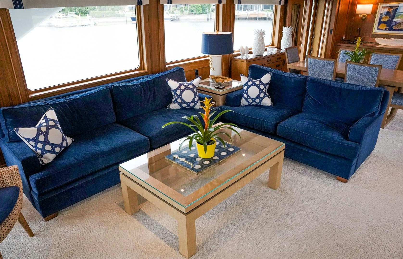 a living room with blue couches aboard RAISING DOUGH Yacht for Sale