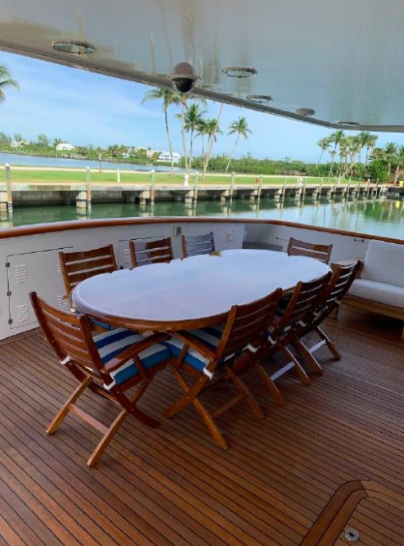 a table and chairs on a deck aboard RAISING DOUGH Yacht for Sale
