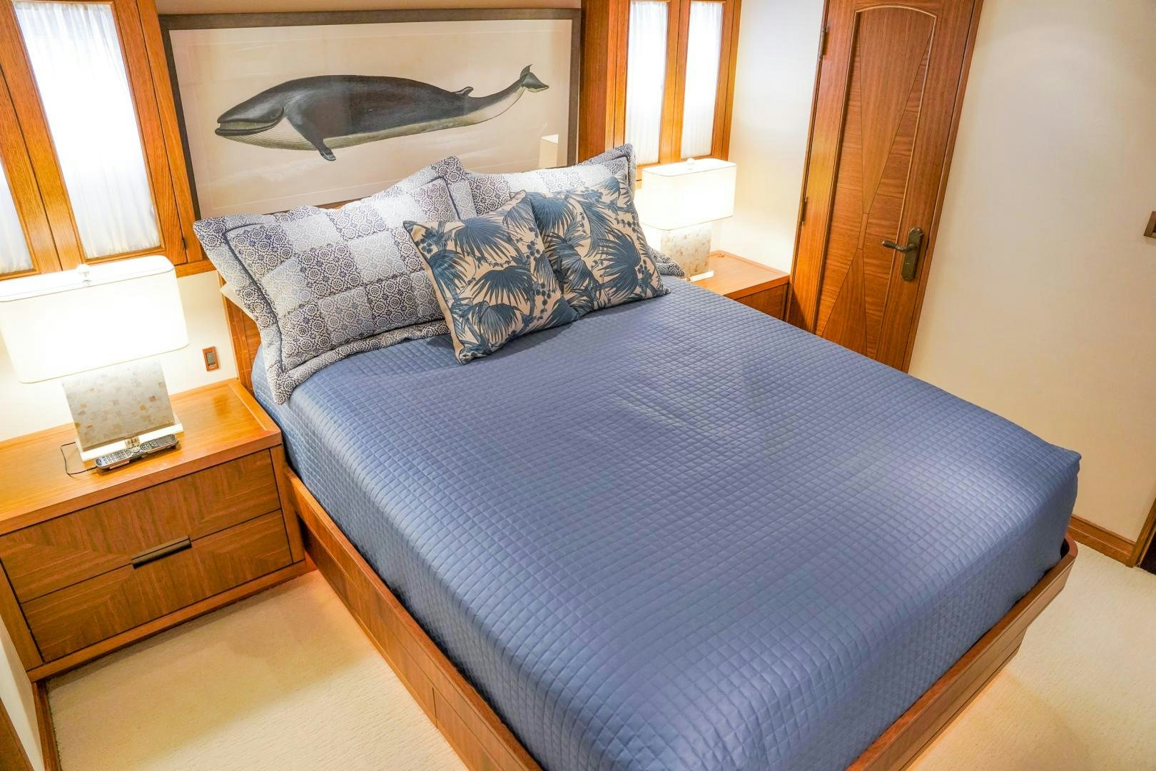 a bed with blue sheets aboard RAISING DOUGH Yacht for Sale