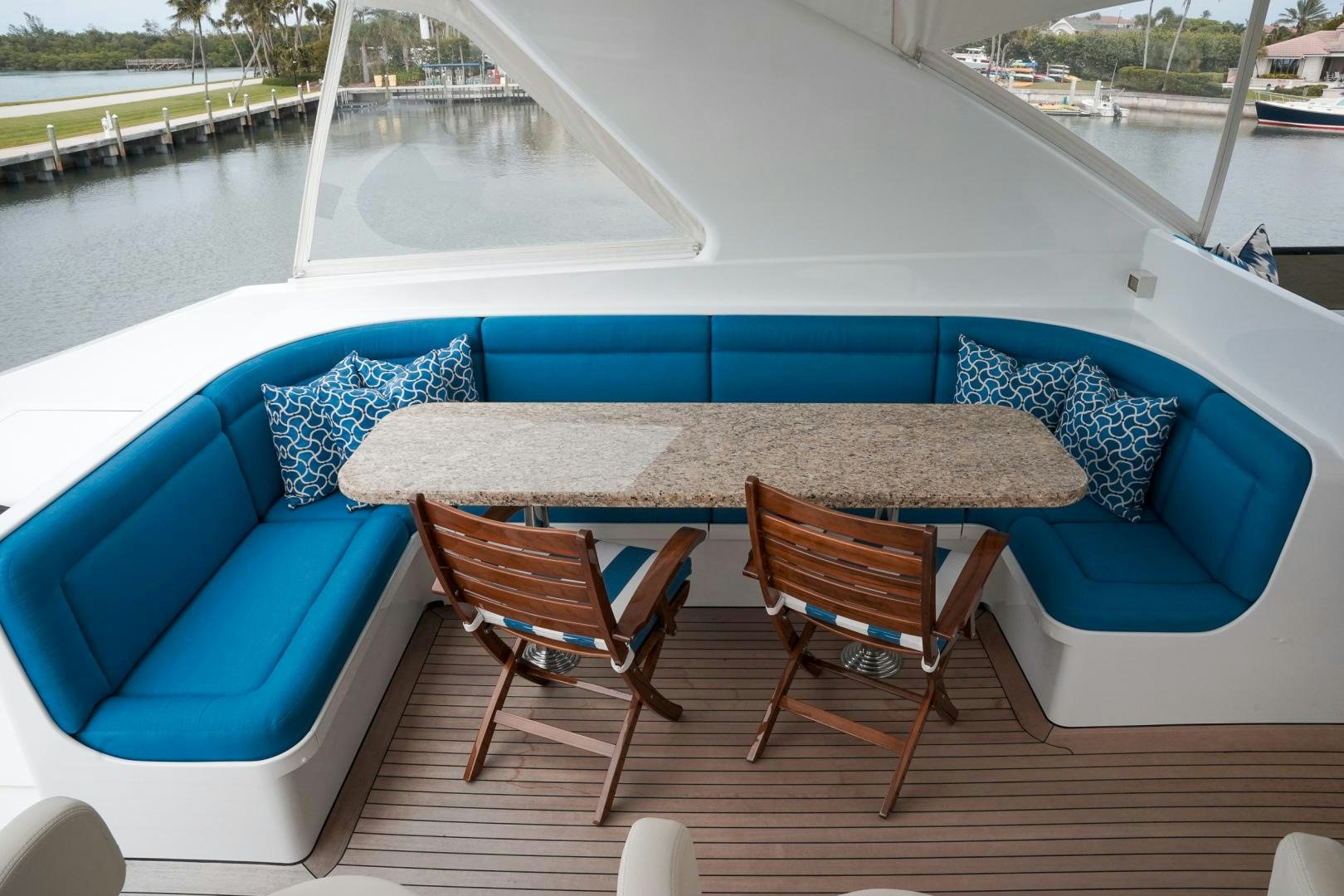 a table and chairs on a deck aboard RAISING DOUGH Yacht for Sale