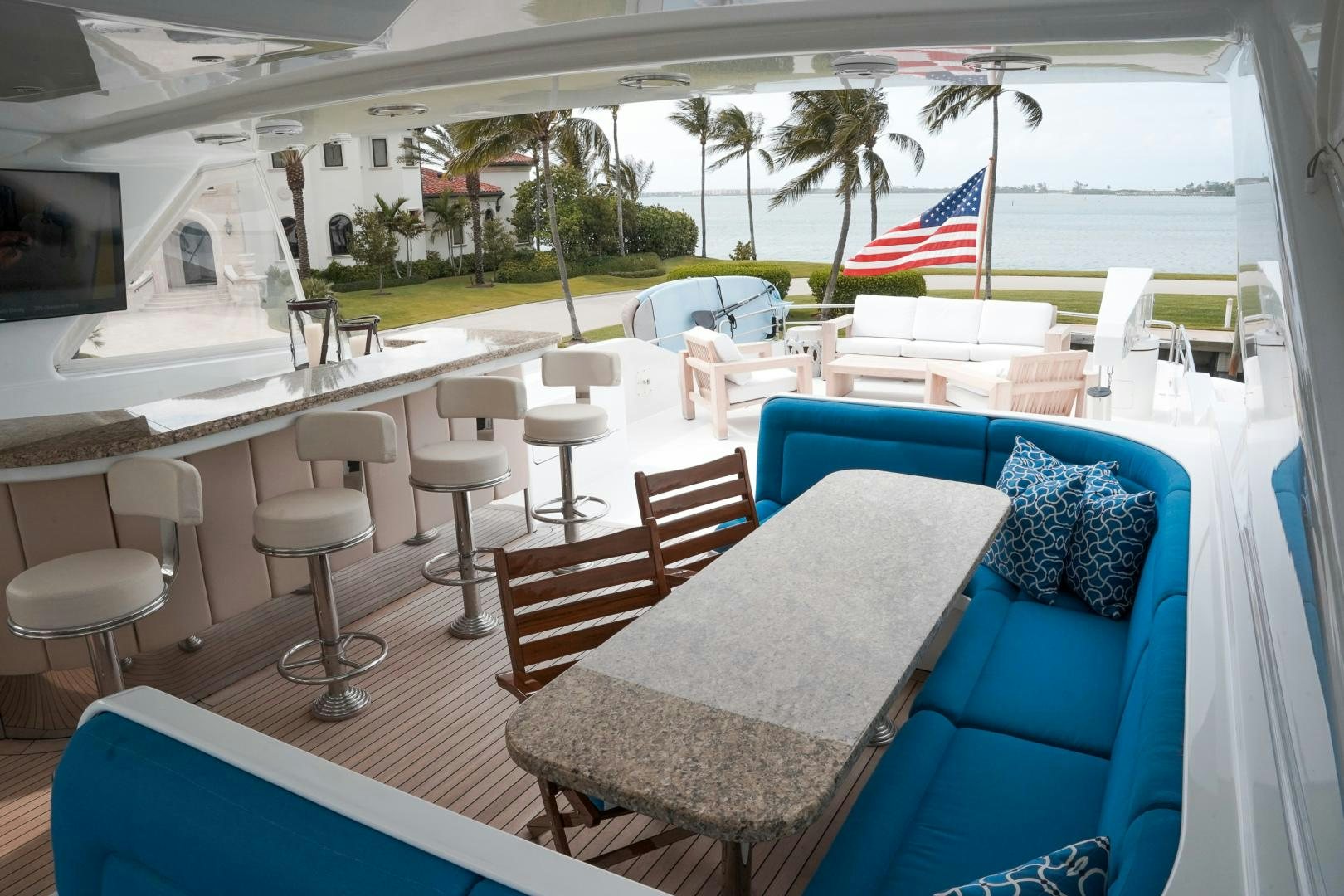a patio with chairs and tables aboard RAISING DOUGH Yacht for Sale