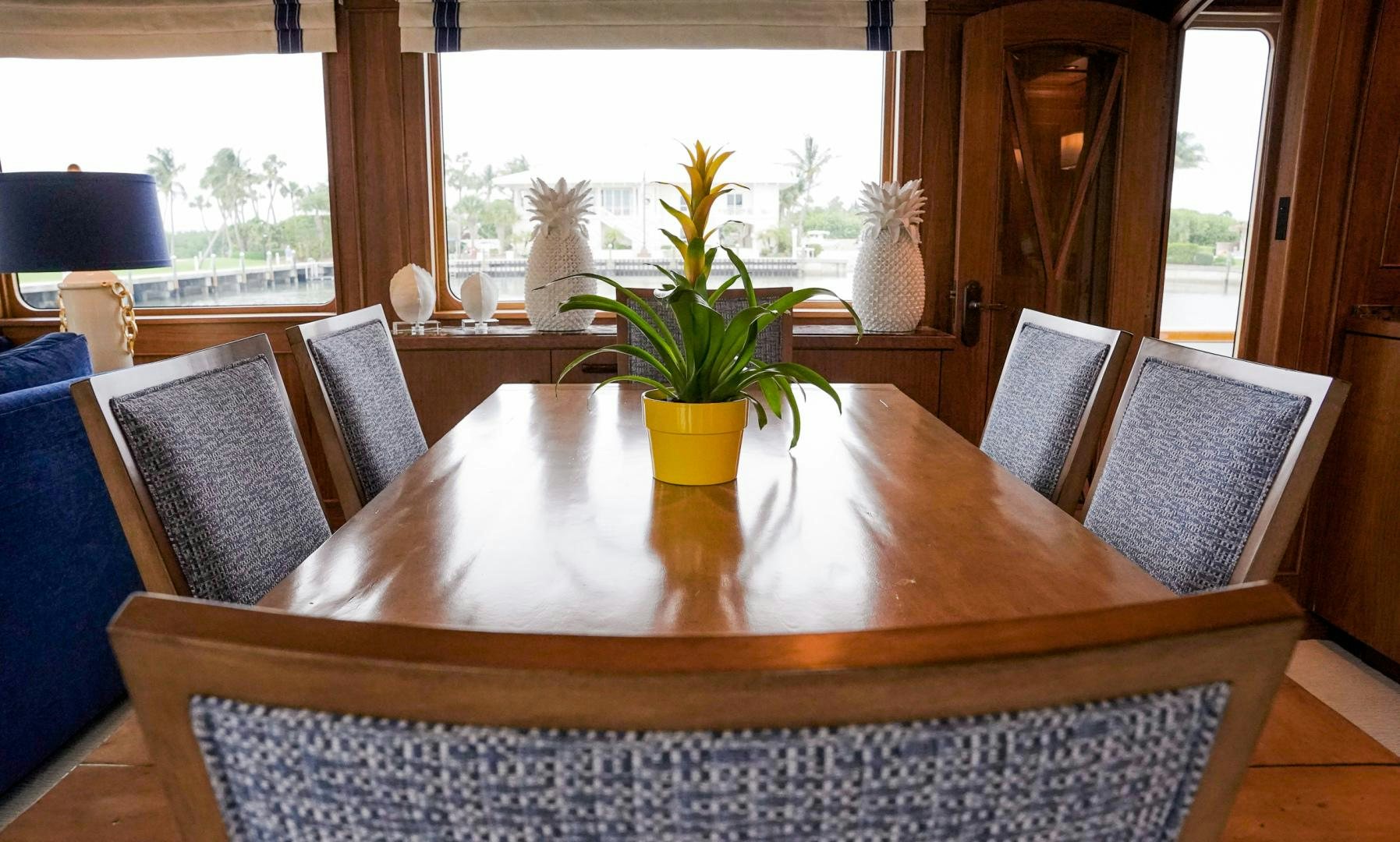 a table with chairs and plants aboard RAISING DOUGH Yacht for Sale