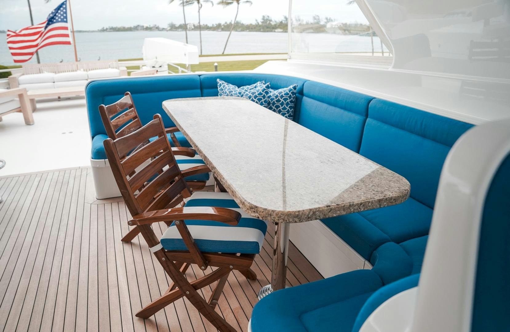 a table and chairs on a deck aboard RAISING DOUGH Yacht for Sale