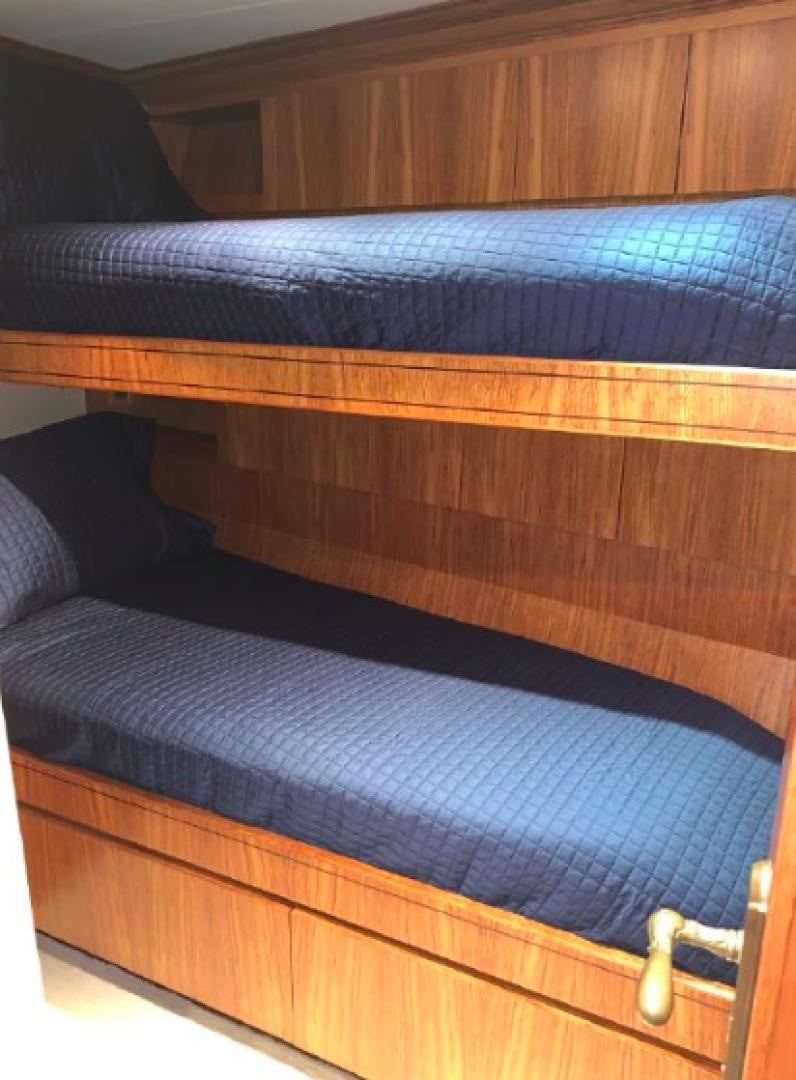 a bed with a blue blanket aboard RAISING DOUGH Yacht for Sale