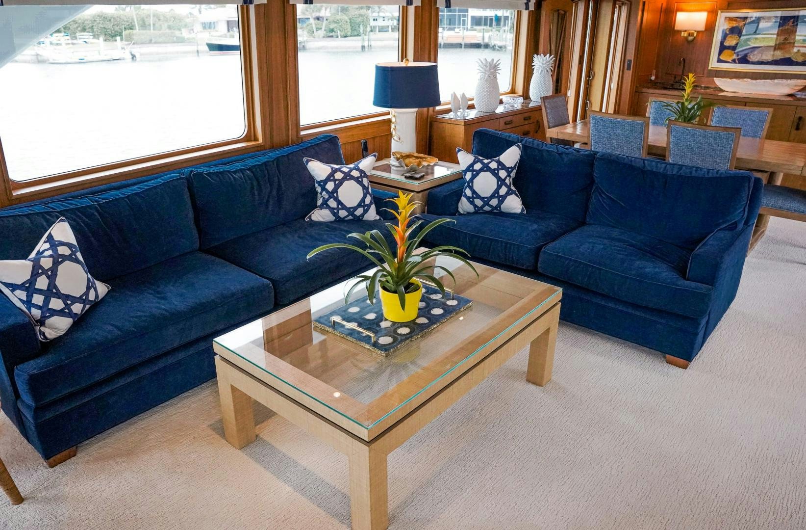 a living room with blue couches aboard RAISING DOUGH Yacht for Sale
