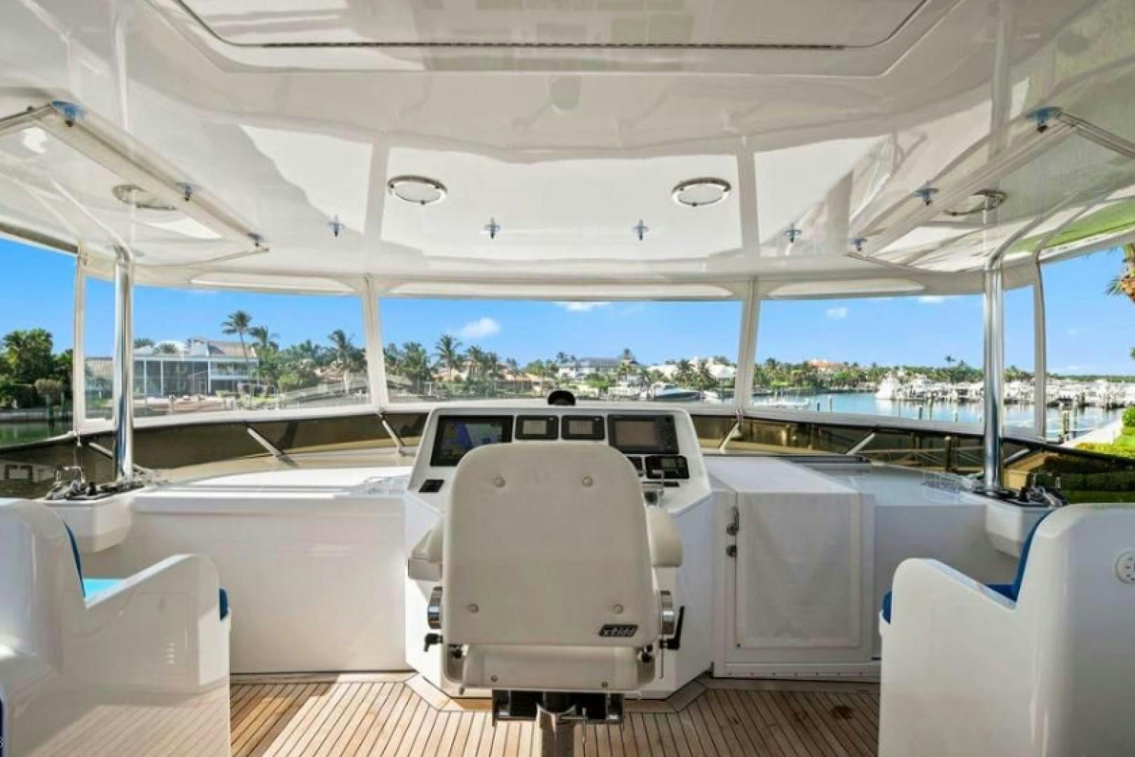 a boat with a chair and a table on it aboard RAISING DOUGH Yacht for Sale