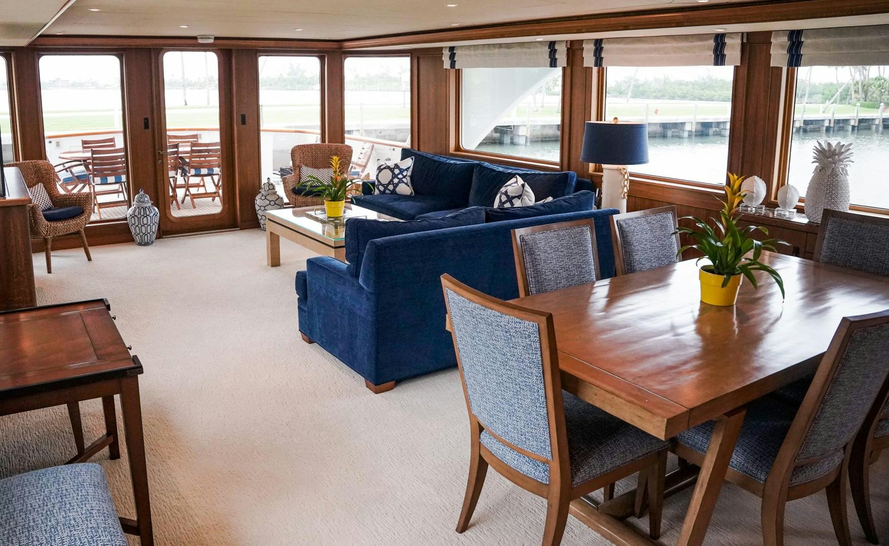 a living room with a blue couch aboard RAISING DOUGH Yacht for Sale