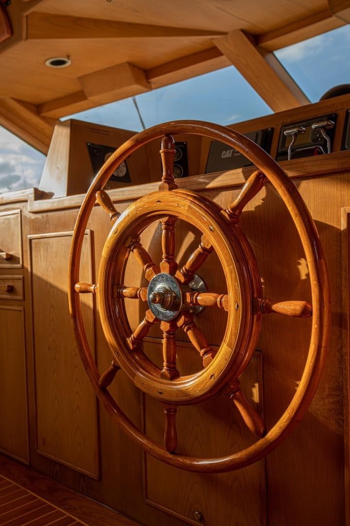 a wooden wheel with a wooden frame aboard ZANTINO III Yacht for Sale
