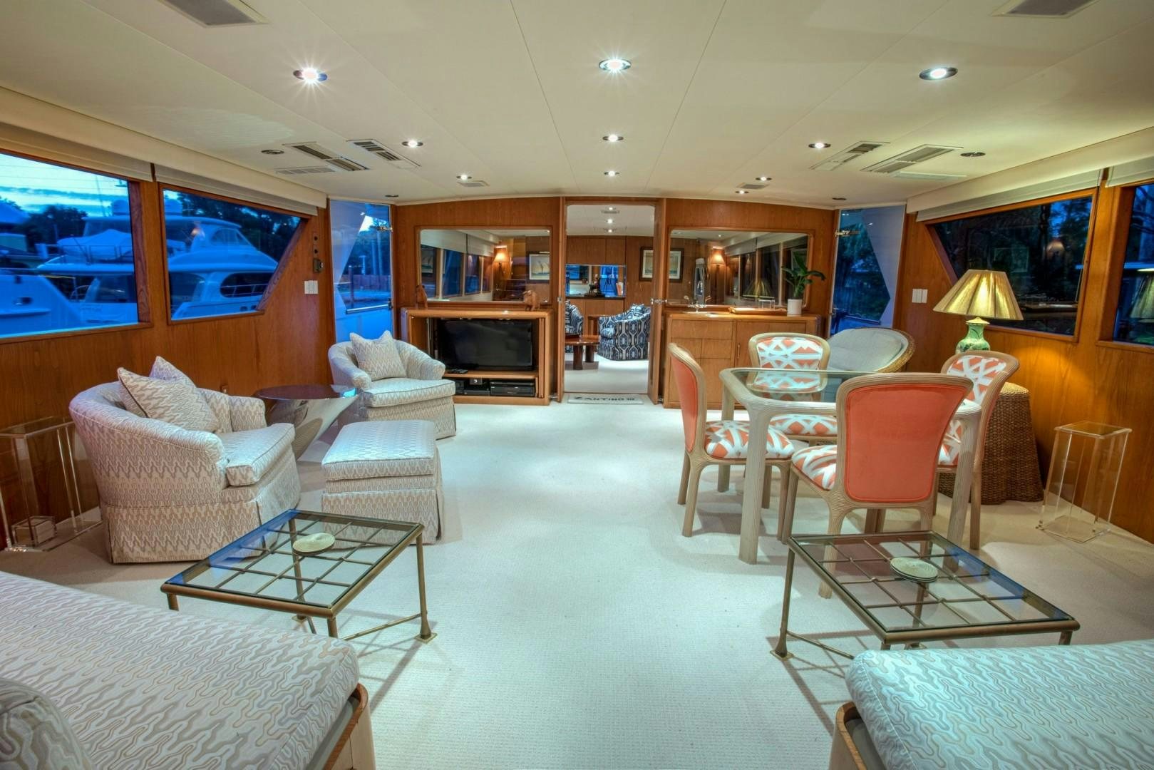 a living room with a table and chairs aboard ZANTINO III Yacht for Sale